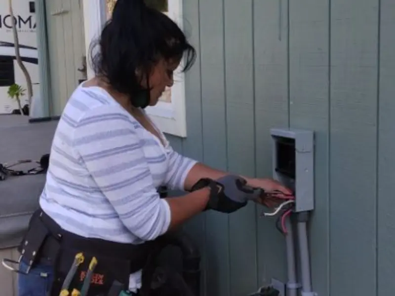 Licensed electrician wiring an exterior subpanel in Paw Paw